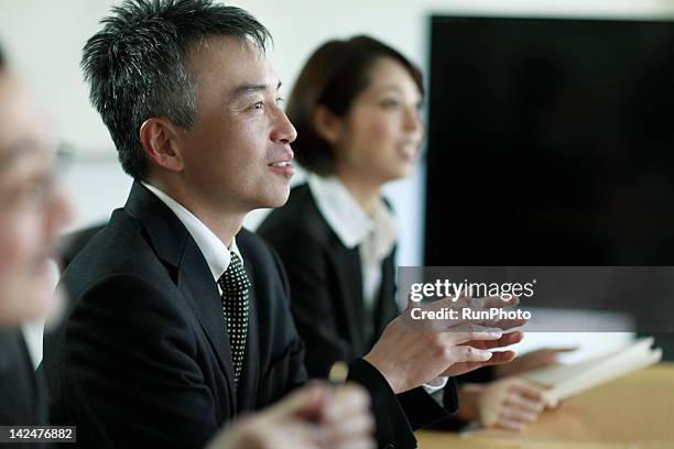 businesspeople having meeting in the office - 50 year old japanese woman stock pictures, royalty-free photos & images