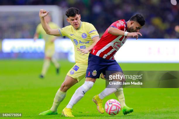 Richard Sanchez of America fights for the ball with Alexis Vega of Chivas during the 15th round match between America and Chivas as part of the...