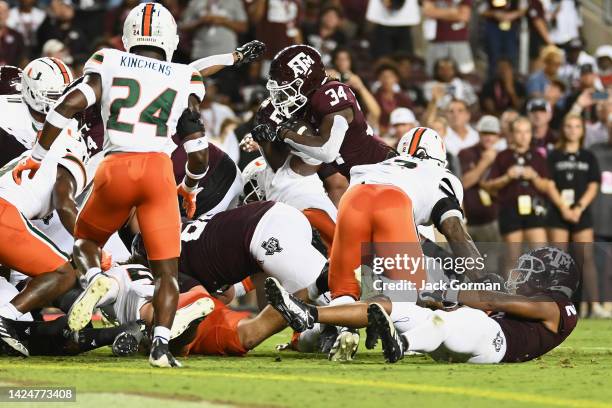 Johnson Jr. #34 of the Texas A&M Aggies dives for a touchdown against the Miami Hurricanes during the first quarter of the game at Kyle Field on...