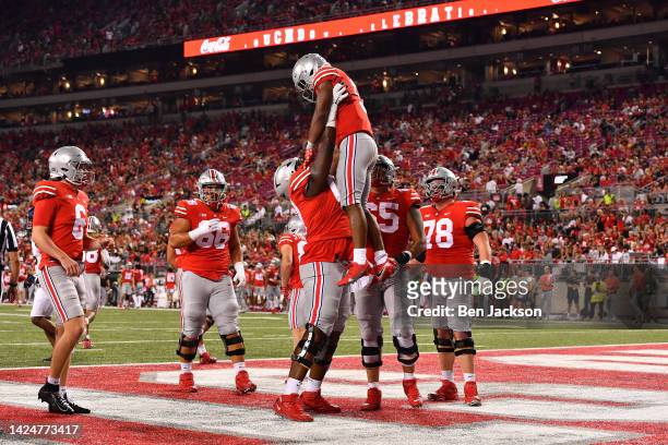 Dallan Hayden of the Ohio State Buckeyes celebrates his fourth quarter touchdown with teammate Tegra Tshabola of the Ohio State Buckeyes during a...