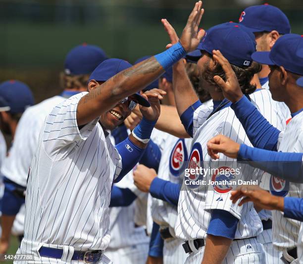 Marlon Byrd of the Chicago Cubs greets teammates during player introductions before the opening day game against the Washington Nationals at Wrigley...