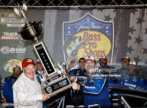 Chris Buescher, driver of the Fastenal Ford, is presented the Bristol Motor Speedway trophy by Johnny Morris, founder and CEO of Bass Pro Shops in...