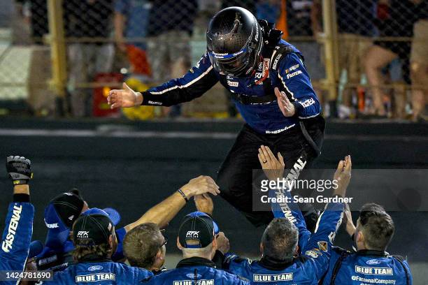 Chris Buescher, driver of the Fastenal Ford, and crew celebrate after winning the NASCAR Cup Series Bass Pro Shops Night Race at Bristol Motor...