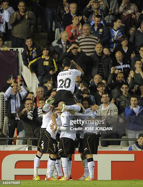 Valencia's players celebrate after Valencia's midfielder Jordi Alba scored during the UEFA Europe League quarter-final second leg football match...