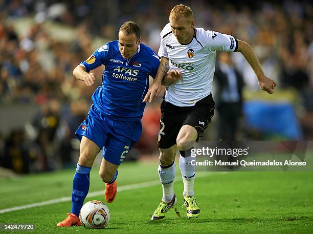 Jeremy Mathieu of Valencia CF competes for the ball with Roy Beerens of AZ Alkmaar during the UEFA Europa League quarter final second leg match...