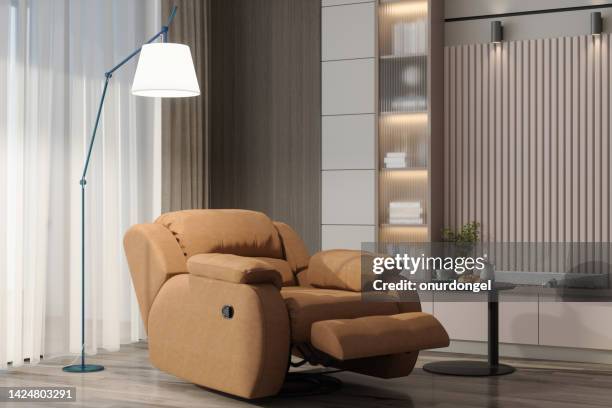 close-up view of reclining chair in living room - recliner chair stock pictures, royalty-free photos & images