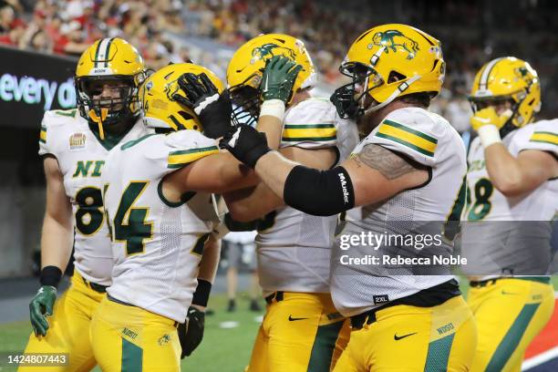 Fullback Hunter Luepke of the North Dakota State Bison celebrates his touchdown with teammates during the second half of the NCAA football game...