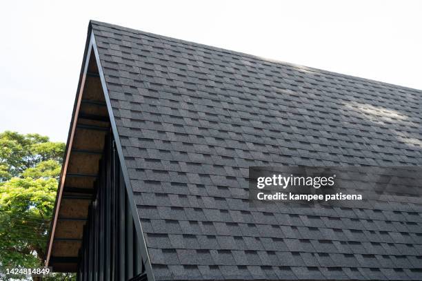 tab styled asphalt roof shingles - tetto foto e immagini stock
