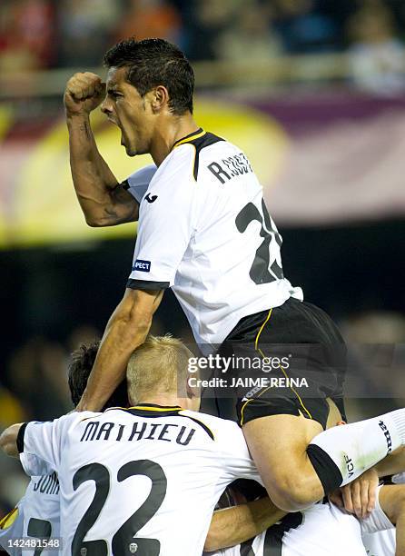 Valencia's players celebrate after scoring during the UEFA Europa League quarter-final second leg football match between Valencia and AZ Alkmaar on...