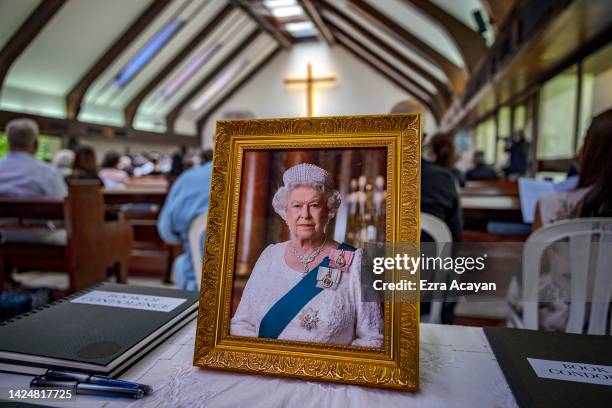 Portrait of the late Queen Elizabeth II is seen during a memorial service at the Holy Trinity Anglican Episcopal Church on September 18, 2022 in...