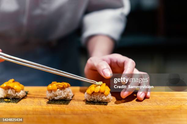 close up of chef making nigiri sushi - fine art stock-fotos und bilder