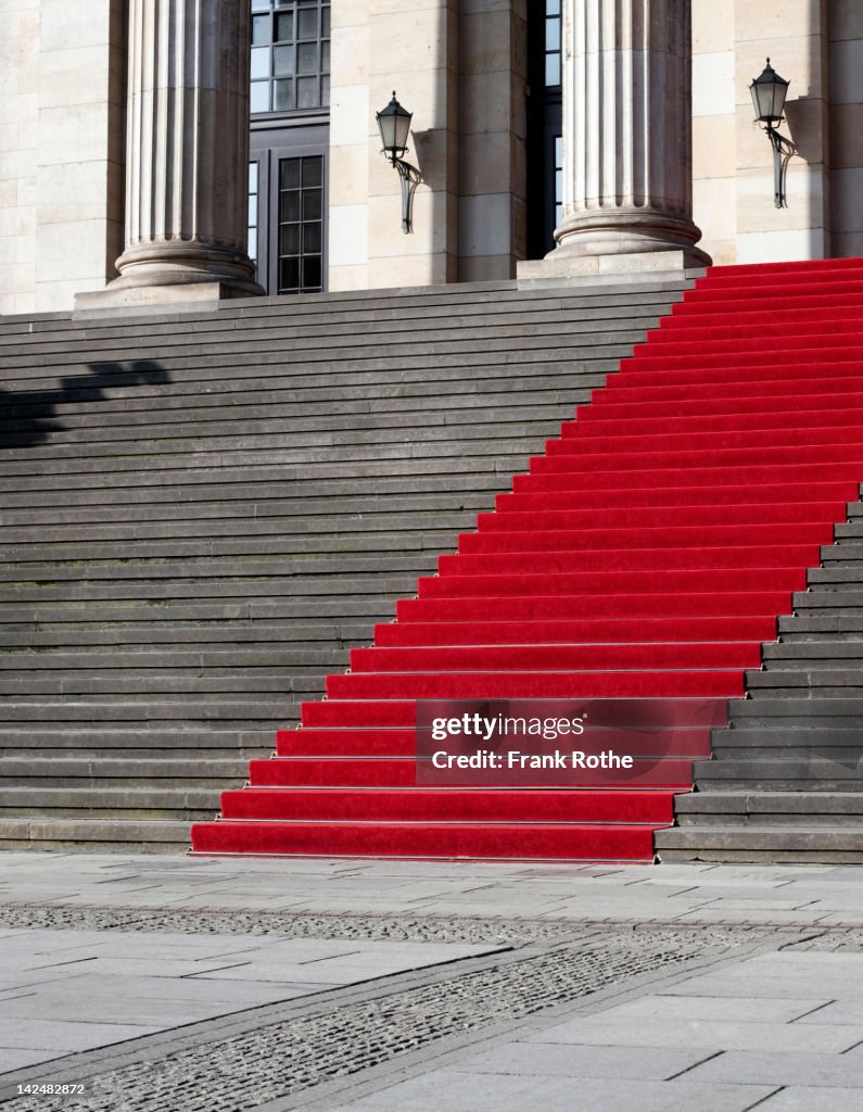 A big good-looking red carpet on real stairs