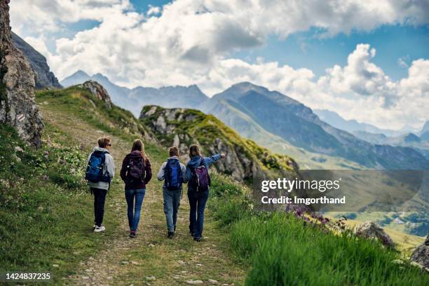 family hiking in the high austrian mountains - alps, tyrol, austria. - girl pointing bildbanksfoton och bilder