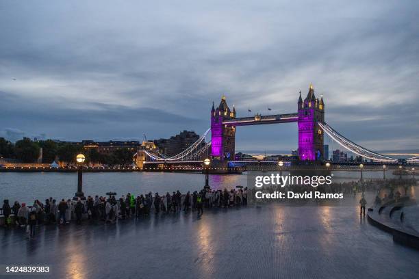 Members of the public walk in line along The Queens Walk near Tower Bridge waiting to pay their respects to Queen Elizabeth II as she lays in state...