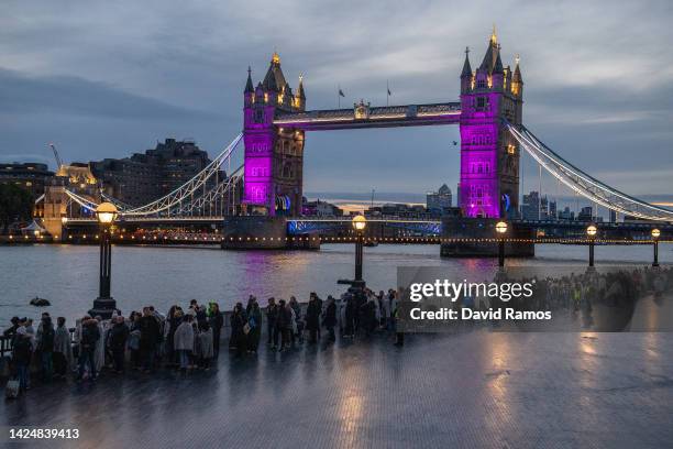 Members of the public walk in line along The Queens Walk near Tower Bridge waiting to pay their respects to Queen Elizabeth II as she lays in state...