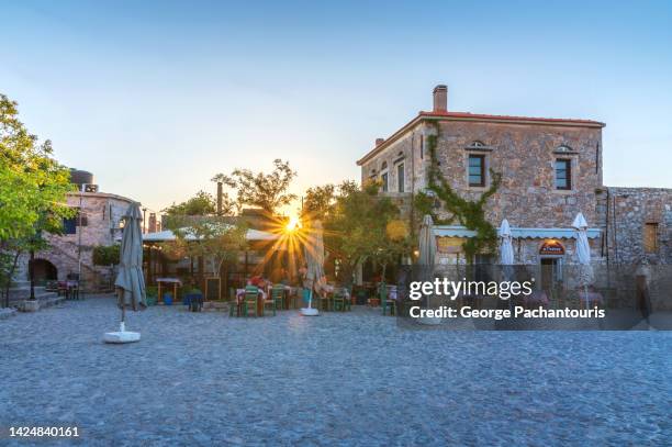 sunset over the square of avgonima village on chios island, greece - greece city bildbanksfoton och bilder