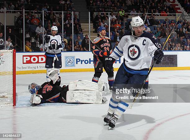 Andrew Ladd of the Winnipeg Jets celebrates his first period goal against the New York Islanders at the Nassau Veterans Memorial Coliseum on April 5,...