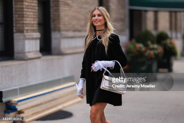 Xenia Adonts seen wearing a black dress, outside coach during new york fashion week on September 12, 2022 in New York City.