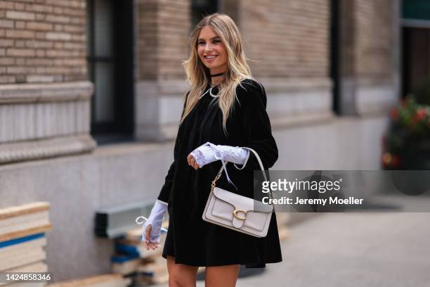 Xenia Adonts seen wearing a black dress, outside coach during new york fashion week on September 12, 2022 in New York City.