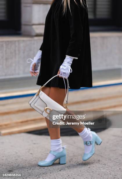 Xenia Adonts seen wearing a black dress, outside coach during new york fashion week on September 12, 2022 in New York City.