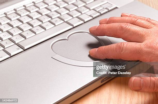 senior man looking for love online - touchpad stock pictures, royalty-free photos & images