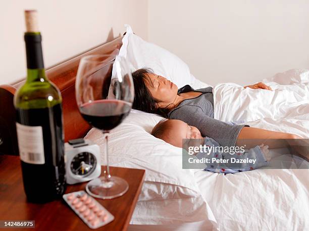 drunk mother sleeping with baby - alcohol abuse stock pictures, royalty-free photos & images