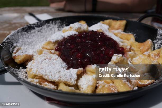 kaiserschmarren with cranberries in an iron pan - kaiserschmarrn stock pictures, royalty-free photos & images