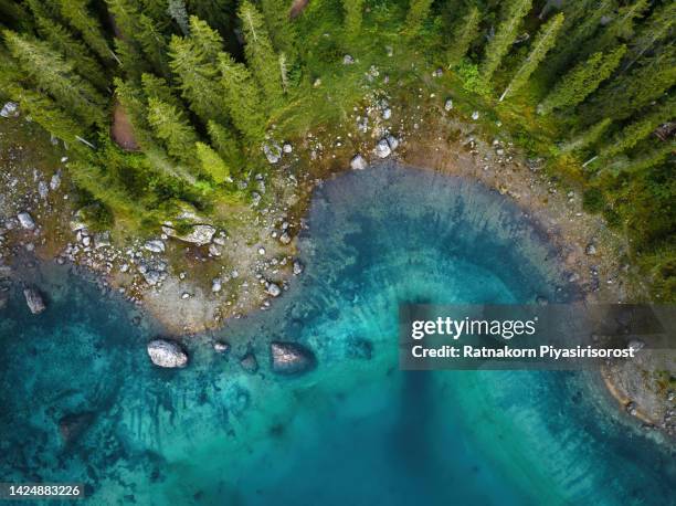 aerial drone sunset scene of italian alps. silent morning on the lake of carezza surrounded by pine forest and mountains. - beautiful sunset stock pictures, royalty-free photos & images