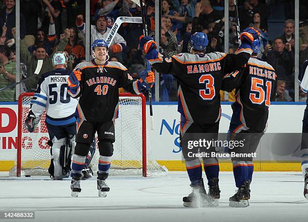 Michael Grabner of the New York Islanders celebrates his game winning goal at 19:13 of the third period against Chris Mason of the Winnipeg Jets at...