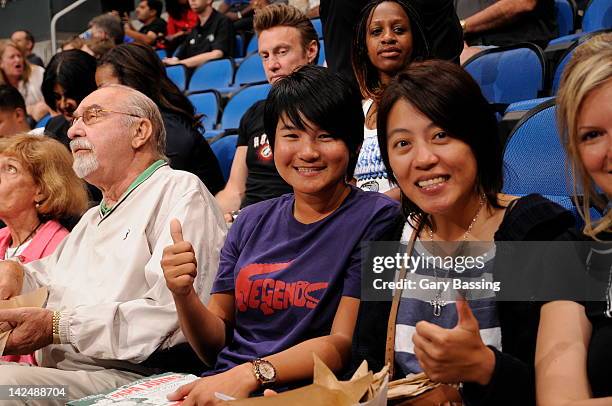 Golfer Yani Tseng, center, currently ranked first in the Women's World Golf Rankings attends the game between the New York Knicks and the Orlando...