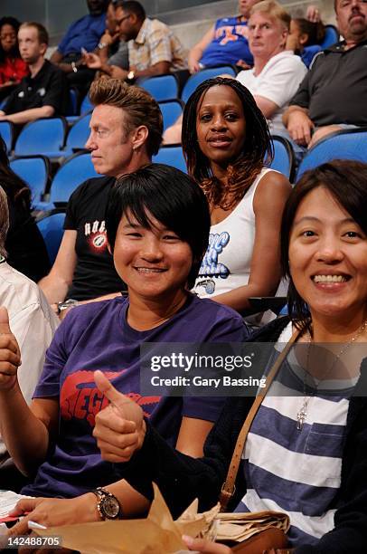 Golfer Yani Tseng, left, currently ranked first in the Women's World Golf Rankings attends the game between the New York Knicks and the Orlando Magic...