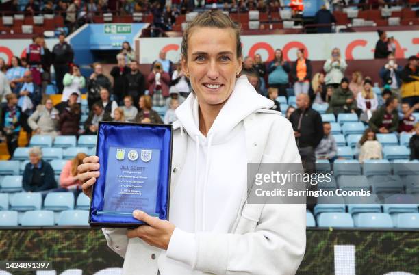 Former Professional Footballer, Jill Scott MBE poses with an award at half-time during the FA Women's Super League match between Aston Villa and...