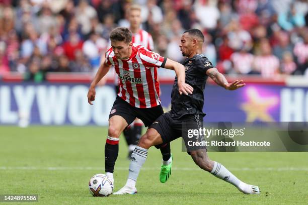 Aaron Hickey of Brentford is challenged by Gabriel Jesus of Arsenal during the Premier League match between Brentford FC and Arsenal FC at Brentford...