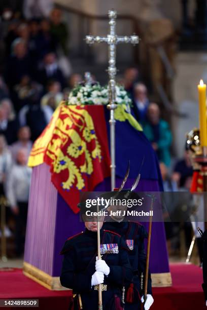 King's Bodyguard from the Royal Company of Archers stand guard where Queen Elizabeth II's flag-draped coffin is lying in state on the catafalque at...