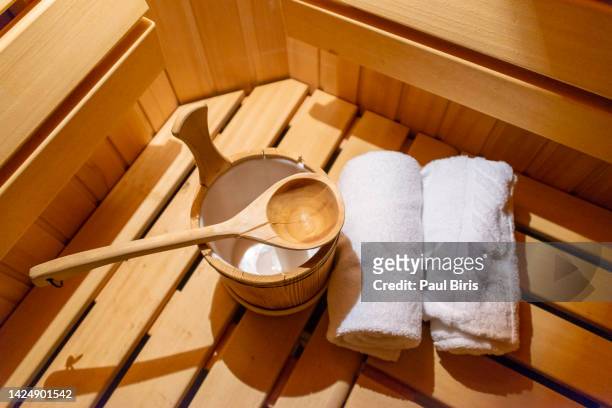 indoor of a finnish sauna, with a water bucket , spa and wellness concept in a hotel - sauna ストックフォトと画像