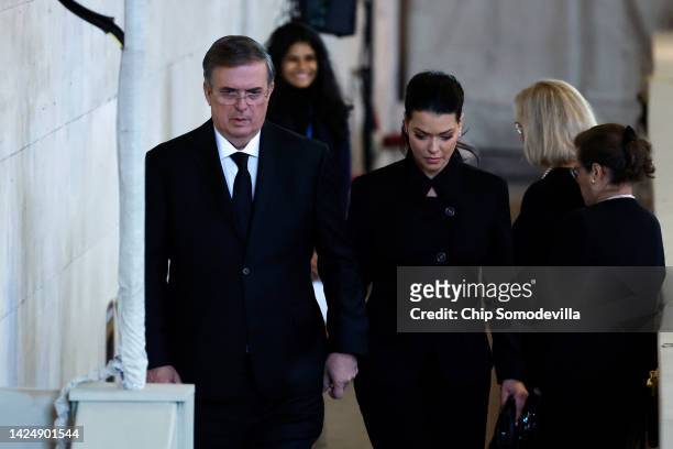 Mexican Foreign Minister Marcelo Ebrard and Rosalinda Bueso Asfura pay their respects to Queen Elizabeth II's flag-draped coffin lying in state on...