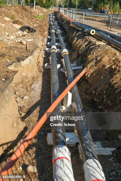 work on laying pipes for district heating in the ground - pipe replacement stock pictures, royalty-free photos & images