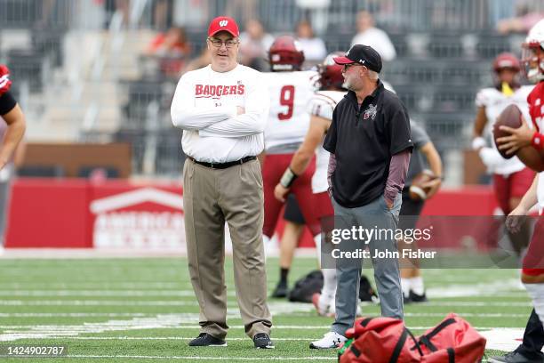 Head coach Paul Chryst of the Wisconsin Badgers talks with head coach Jerry Kill of the New Mexico State Aggies before the game at Camp Randall...