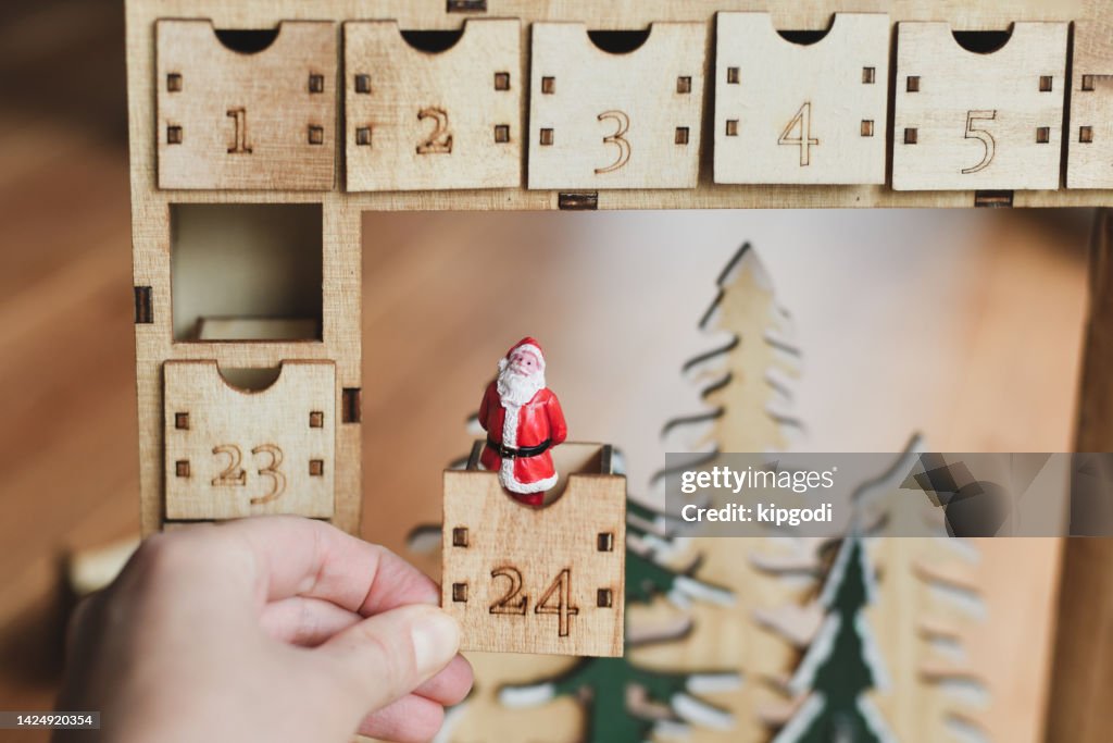 A wooden advent calendar with Santa Claus