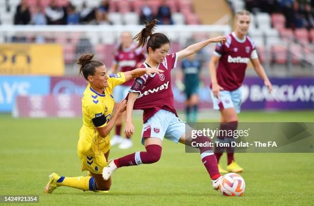 Risa Shimizu of West Ham United is challenged by Danielle Turner of Everton during the FA Women's Super League match between West Ham United and...