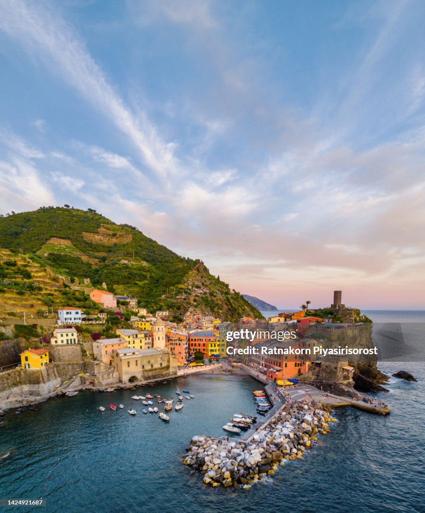 Aerial Drone Sunset Scene of Vernazza is a small town in the province of La Spezia, Liguria, northern Italy. It is the second-smallest of the famous Cinque Terre towns frequented by tourists.