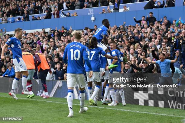 Idrissa Gueye and Vitalii Mykolenko of Everton and team mates celebrate the goal Neal Maupayl during the Premier League match between Everton and...