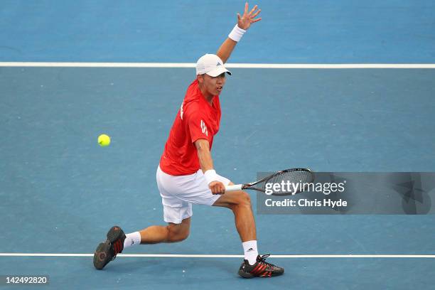 Min-Hyeok Cho of Korea plays a backhand in his singles match against Tomic of Australia on day one of the Davis Cup Asia Oceania Zone Second Round...