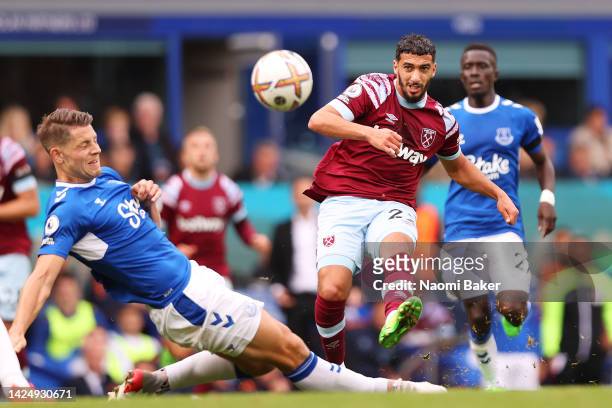 Said Benrahma of West Ham United shoots and hits the crossbar whilst under pressure from James Tarkowski of Everton during the Premier League match...