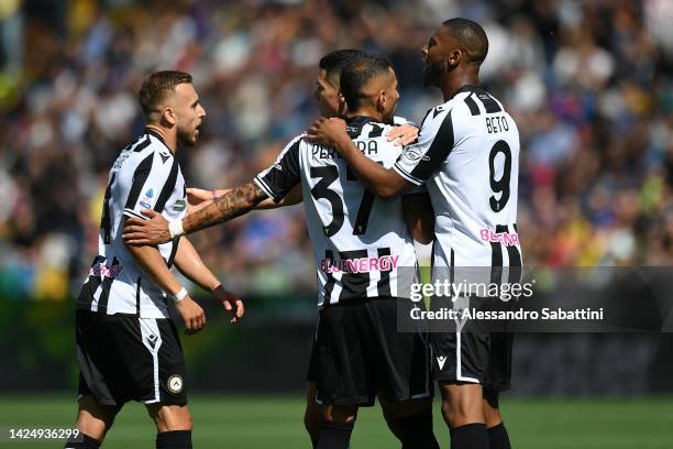 Roberto Pereyra of Udinese Calcio celebrates with teammates Sandi Lovric and Beto during the Serie A match between Udinese Calcio and FC...