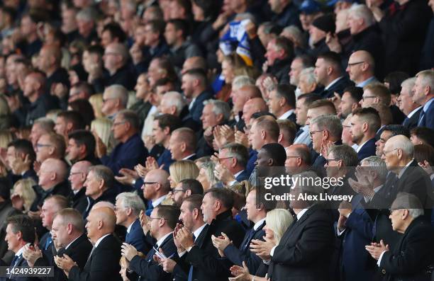 Directors and supporters take part in an applause on the 70th minute as a tribute to Her Majesty Queen Elizabeth II who died at Balmoral Castle on...