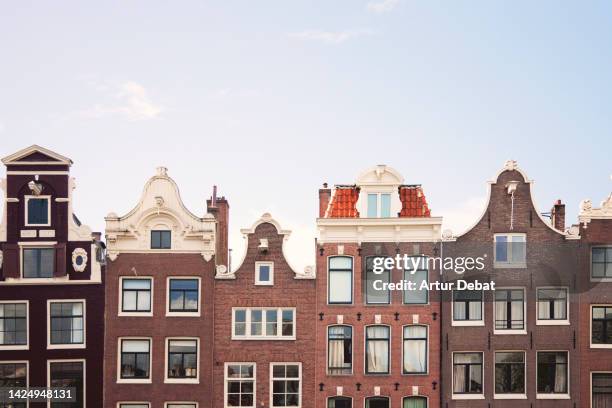 brick façade houses with different shape in amsterdam. - building symmetry stock pictures, royalty-free photos & images