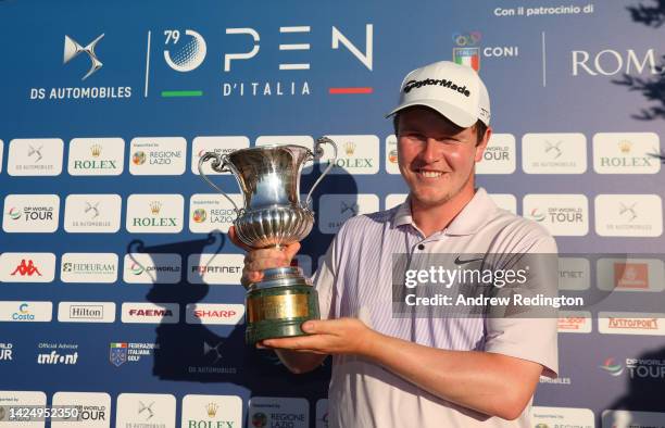 Robert MacIntyre of Scotland with the trophy after winning The Italian Open on Day Four of the DS Automobiles Italian Open 2022 at Marco Simone Golf...