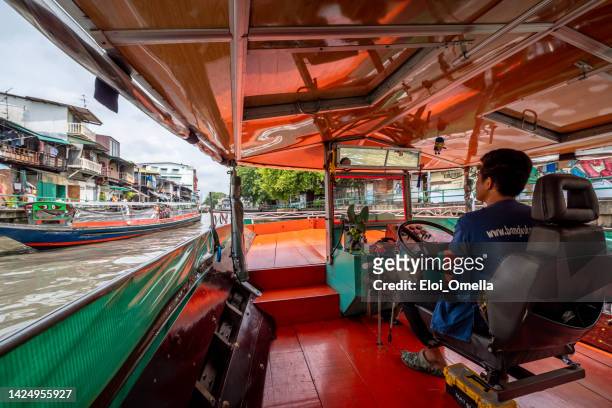 boat driver in the canal bobae market - phanfa bridge in bangkok - bangkok river stock pictures, royalty-free photos & images