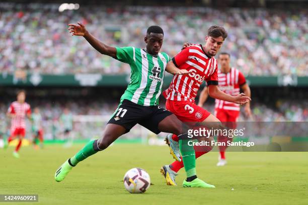 Luiz Henrique of Real Betis battles for possession with Miguel Gutierrez of Girona FC during the LaLiga Santander match between Real Betis and Girona...
